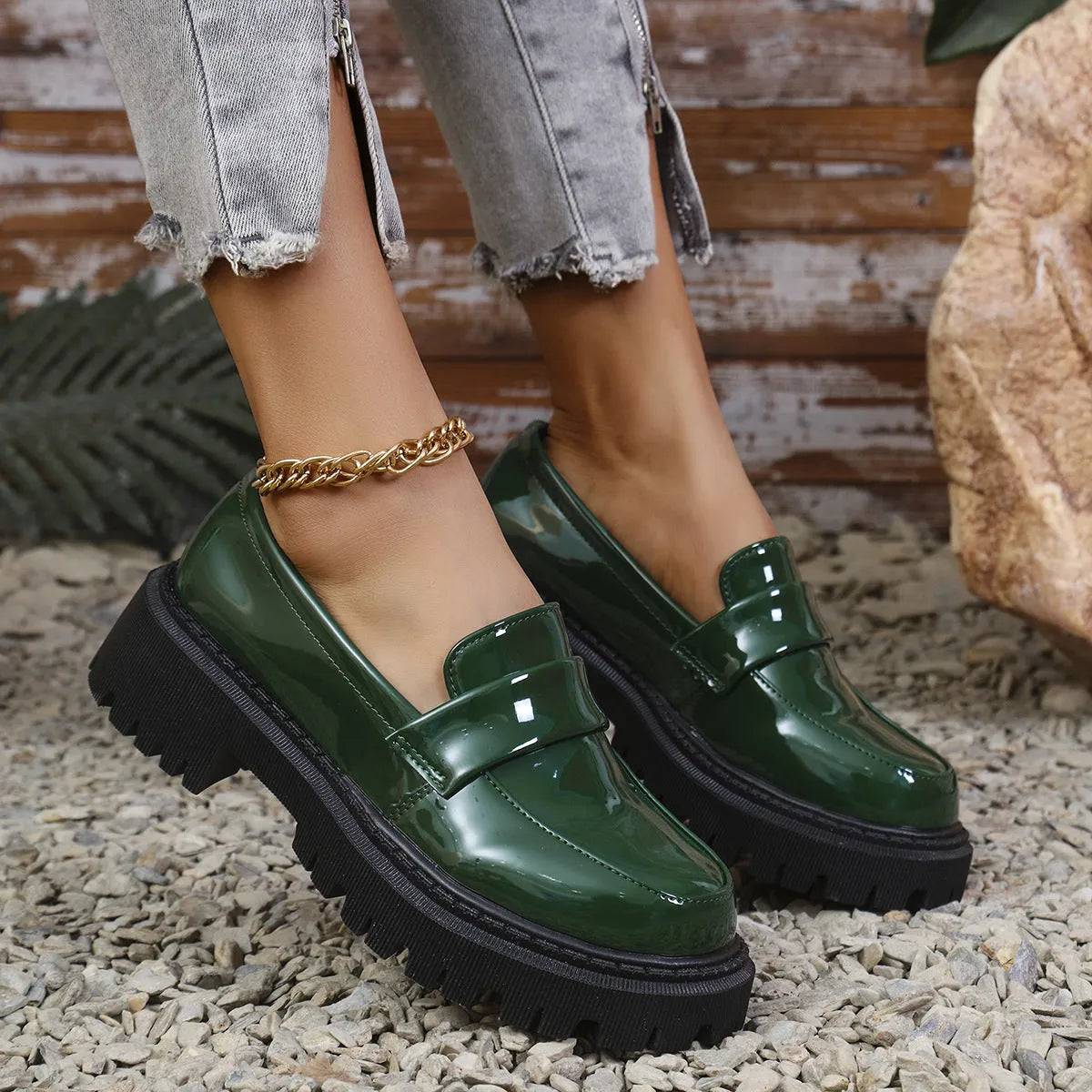Women's black slip-on loafers with a chunky block heel and platform sole, shown from the side.
