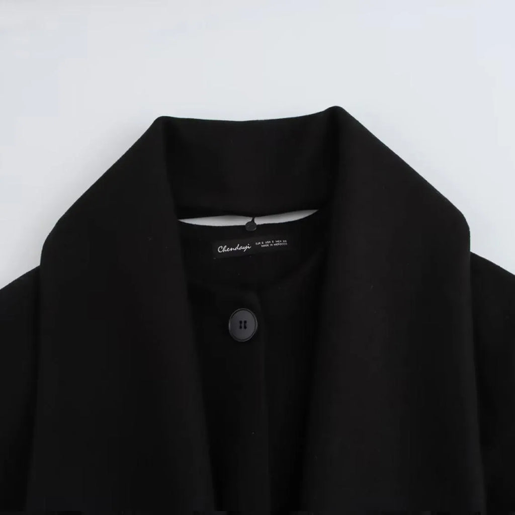 Women's long black polyester overcoat with artificial fur collar, shown at full length.