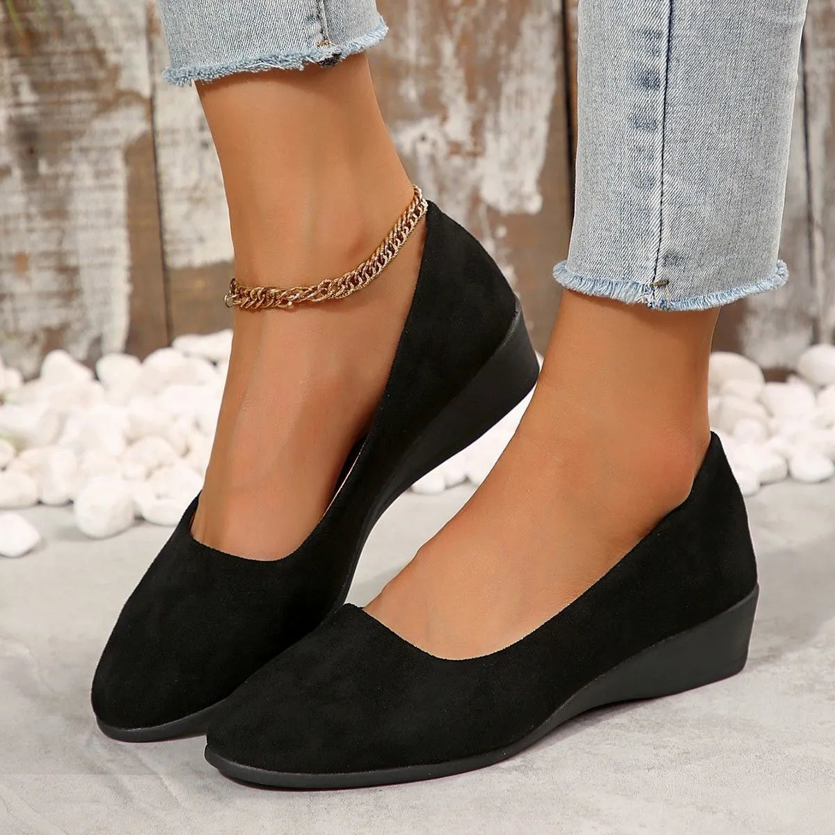 Women's suede wedge pump in light brown with a pointed toe and low rubber sole.