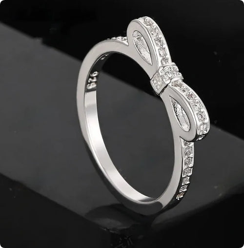 Silver-coloured bow design ring with sparkling rhinestone zircon crystal decoration.