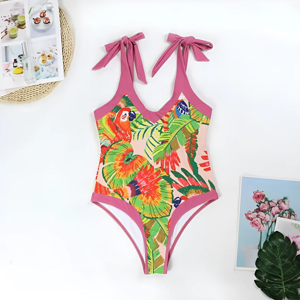 Women's pink floral print one-piece swimsuit with V-neck, covered belly, and attached skirt for swimming