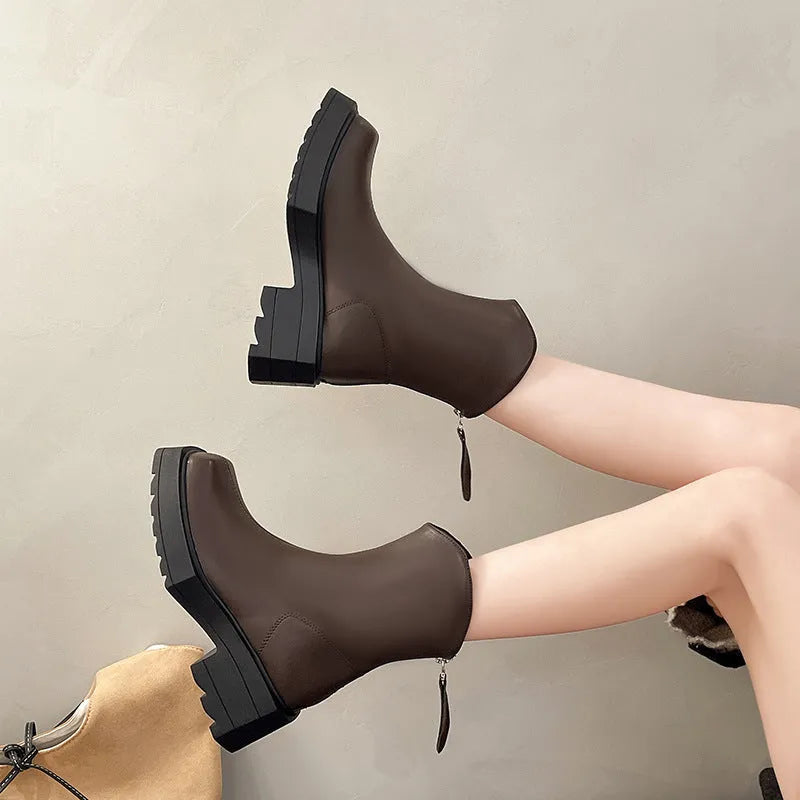 Black and brown platform Martin boots with square toe, high heel, and back zipper closure.