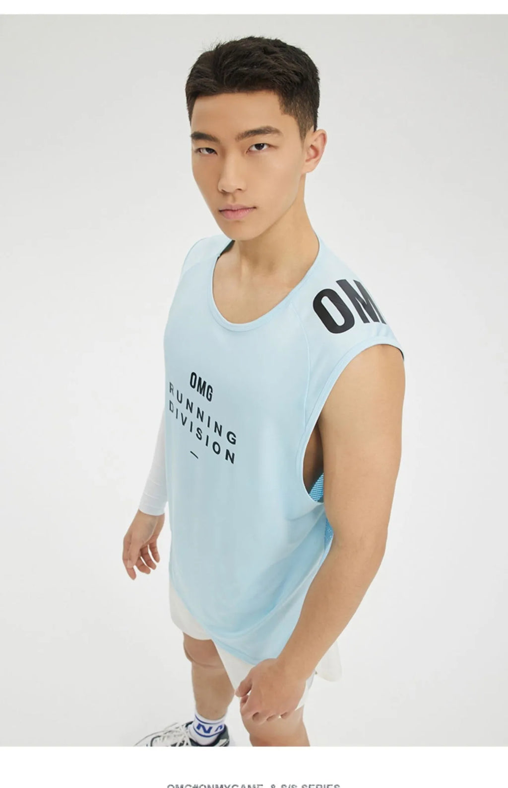 Man wearing a lightweight grey mesh sports vest with a loose fit and straight hem.