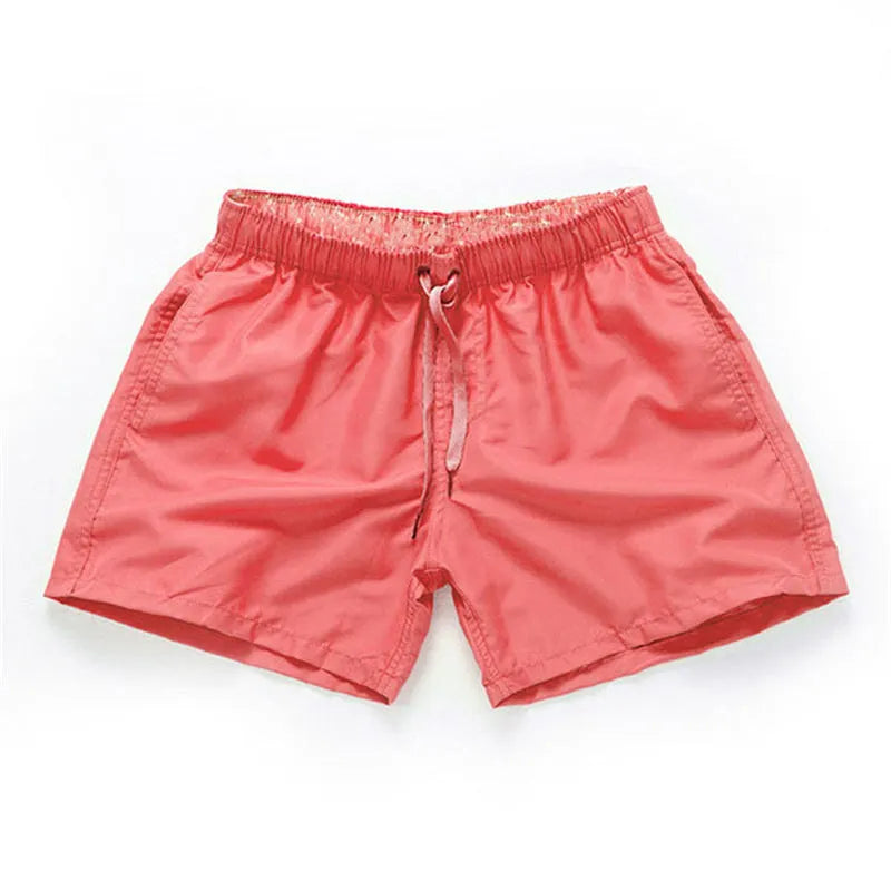 Men's straight-leg beach shorts in polyester fabric shown in a solid colour, laid flat.
