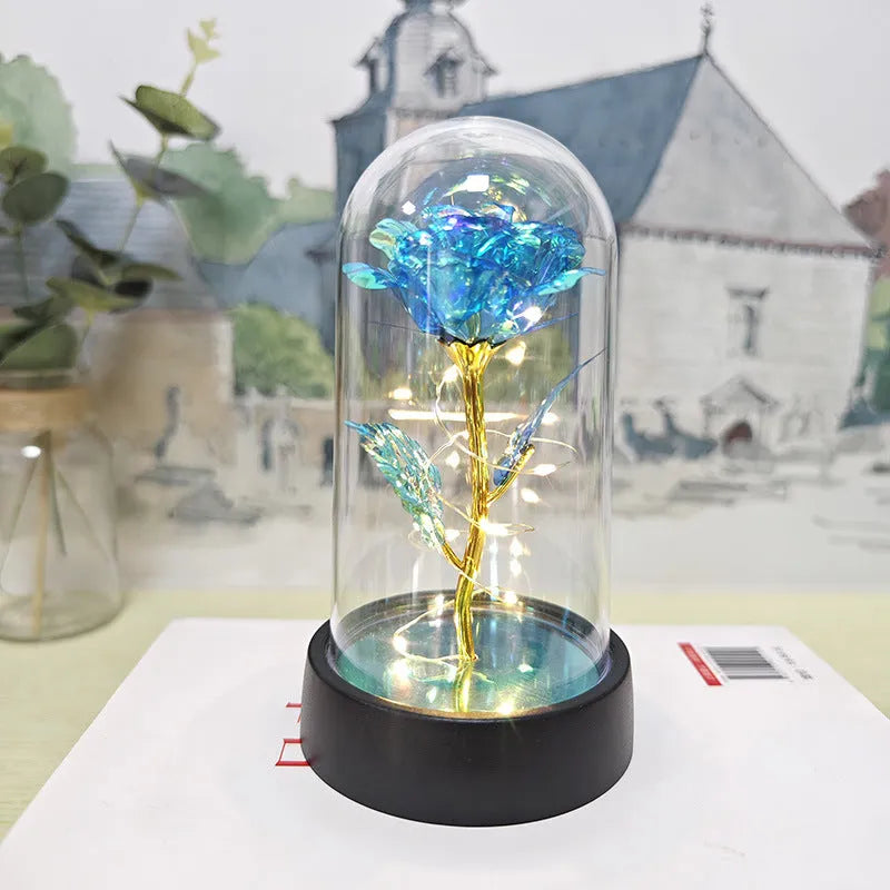 Small plastic night lamp with glass cover and flower decoration on black base