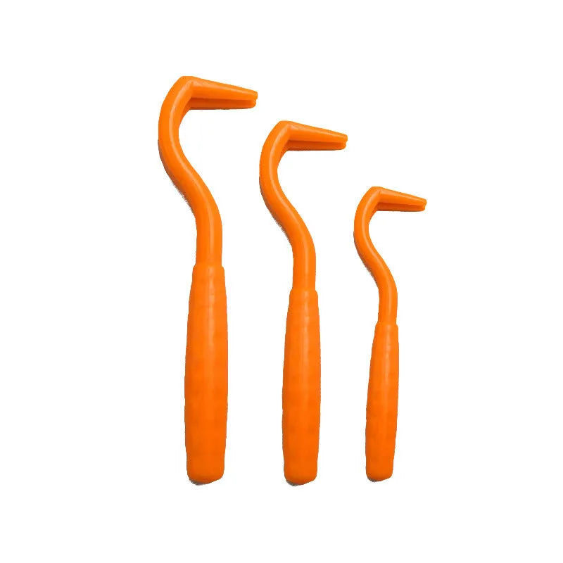 Set of three coloured tick removal hooks for dogs on a white background.