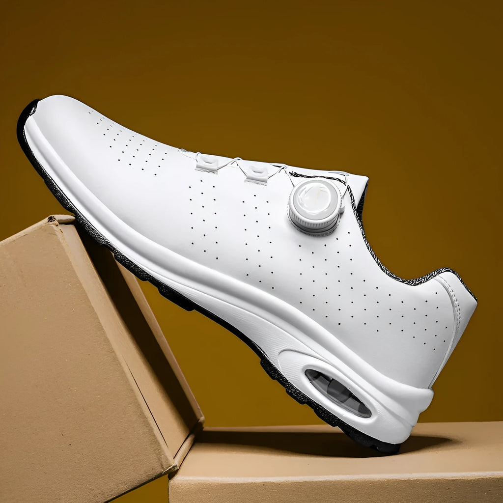 Black and white low-top mesh casual shoes with cross shoulder straps and a composite sole.