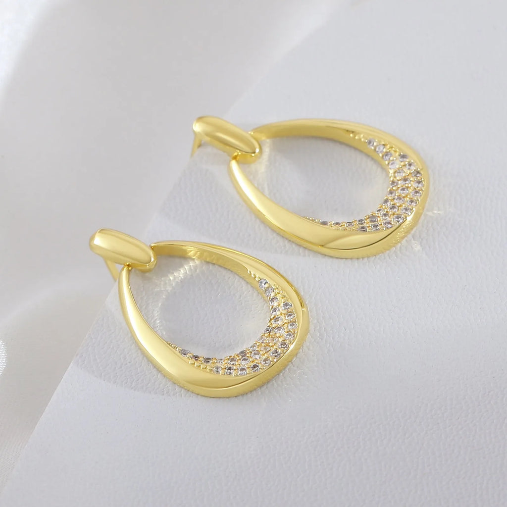 Yellow gold geometric drop earrings for women with a simple ring-style design.