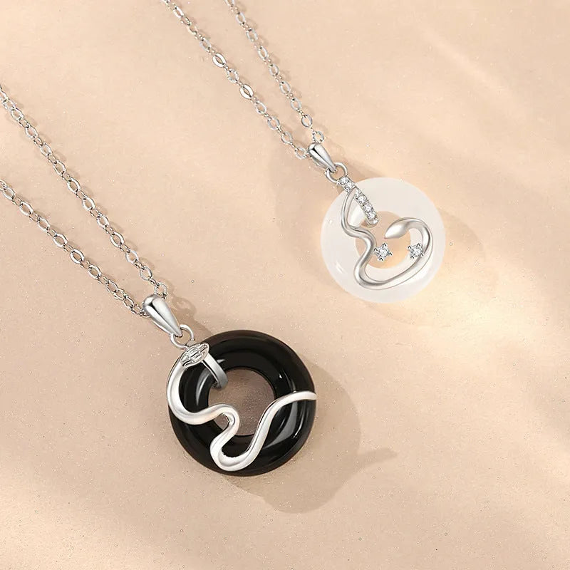 925 sterling silver snake couple necklace with Peace buckle on black background