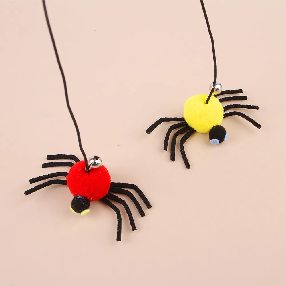 Hanging elastic rope cat toy with feather, bell and spider elements on playing stick in red colour