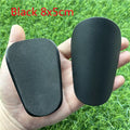 Extra small mini football shin guards in black and white plastic construction
