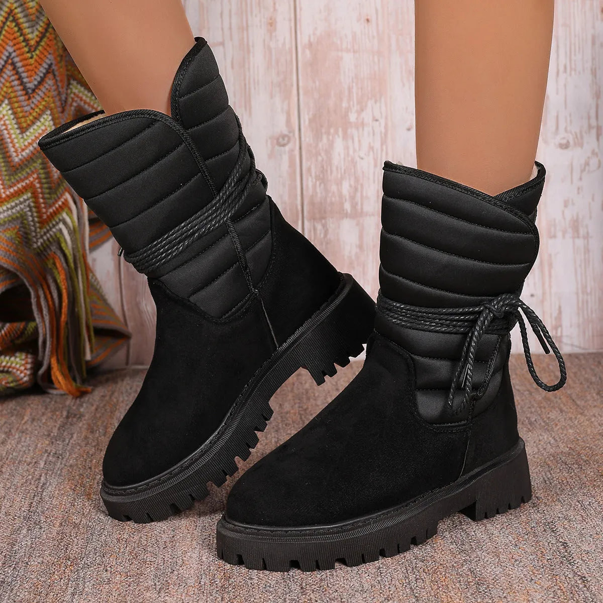 Women's black chunky heel snow boots with lace-up design and fleece lining.