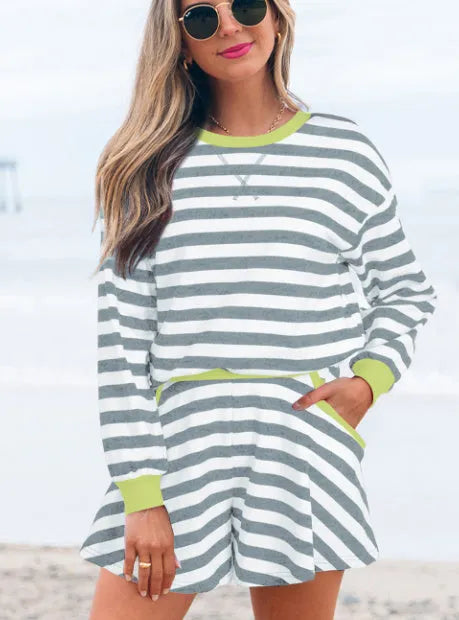 Women's black stripe long sleeve blouse and matching skirt set with contrast ribbed banding.