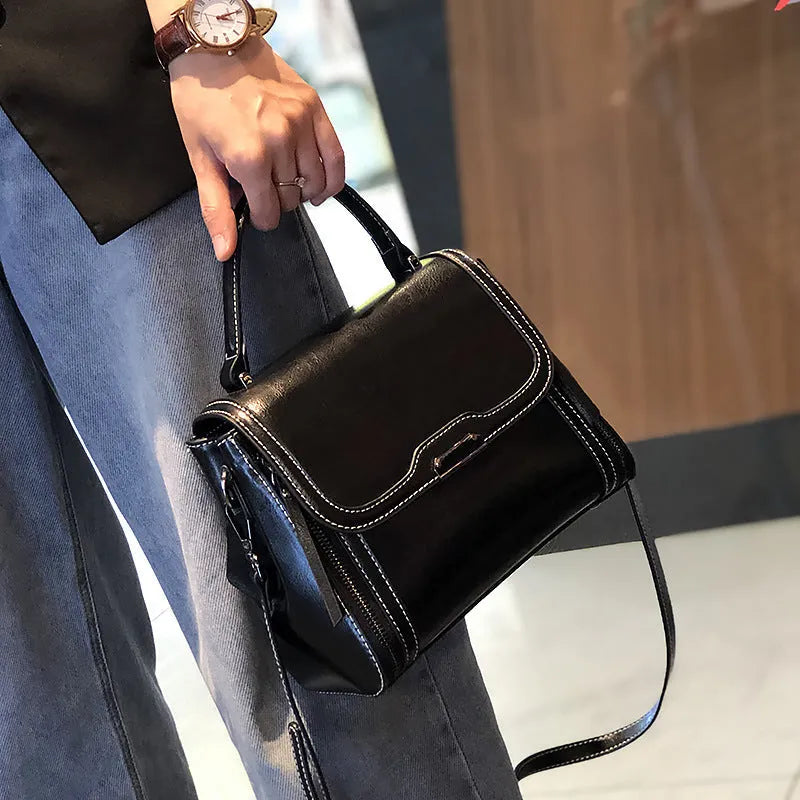 Women's brown genuine leather messenger bag with retro styling and multiple internal pockets