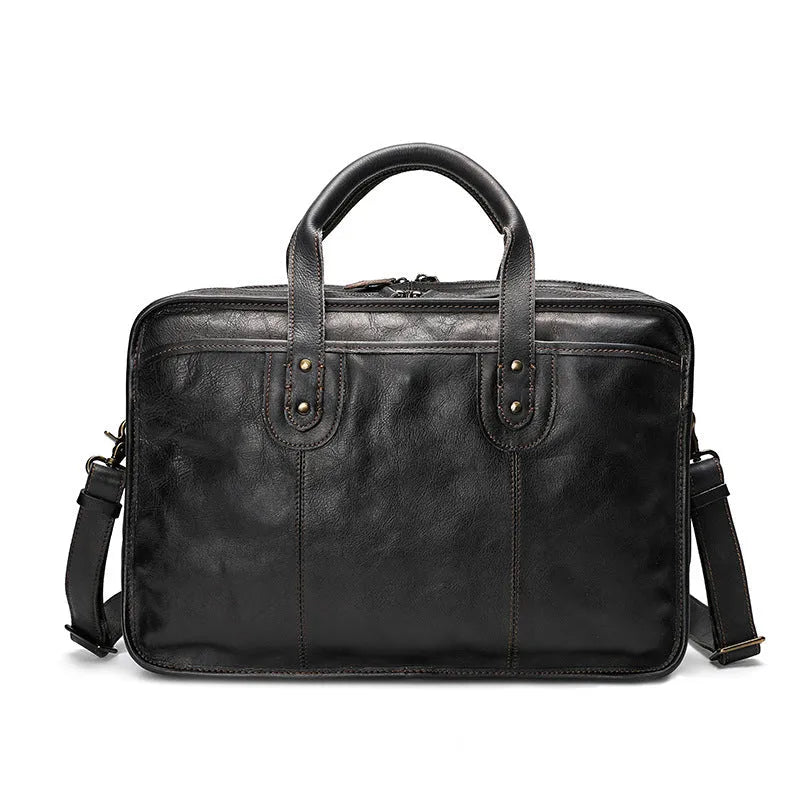 Vintage brown leather men's briefcase open showing internal laptop pocket and document organisers