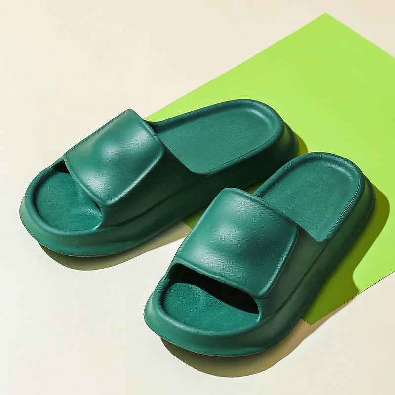 Pair of thick-soled white EVA foam flip-flop slippers on a bathroom floor, showing non-slip tread pattern.