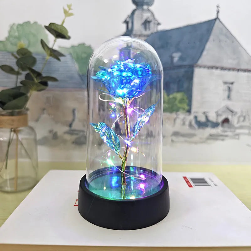 Small plastic night lamp with glass cover and flower decoration on black base