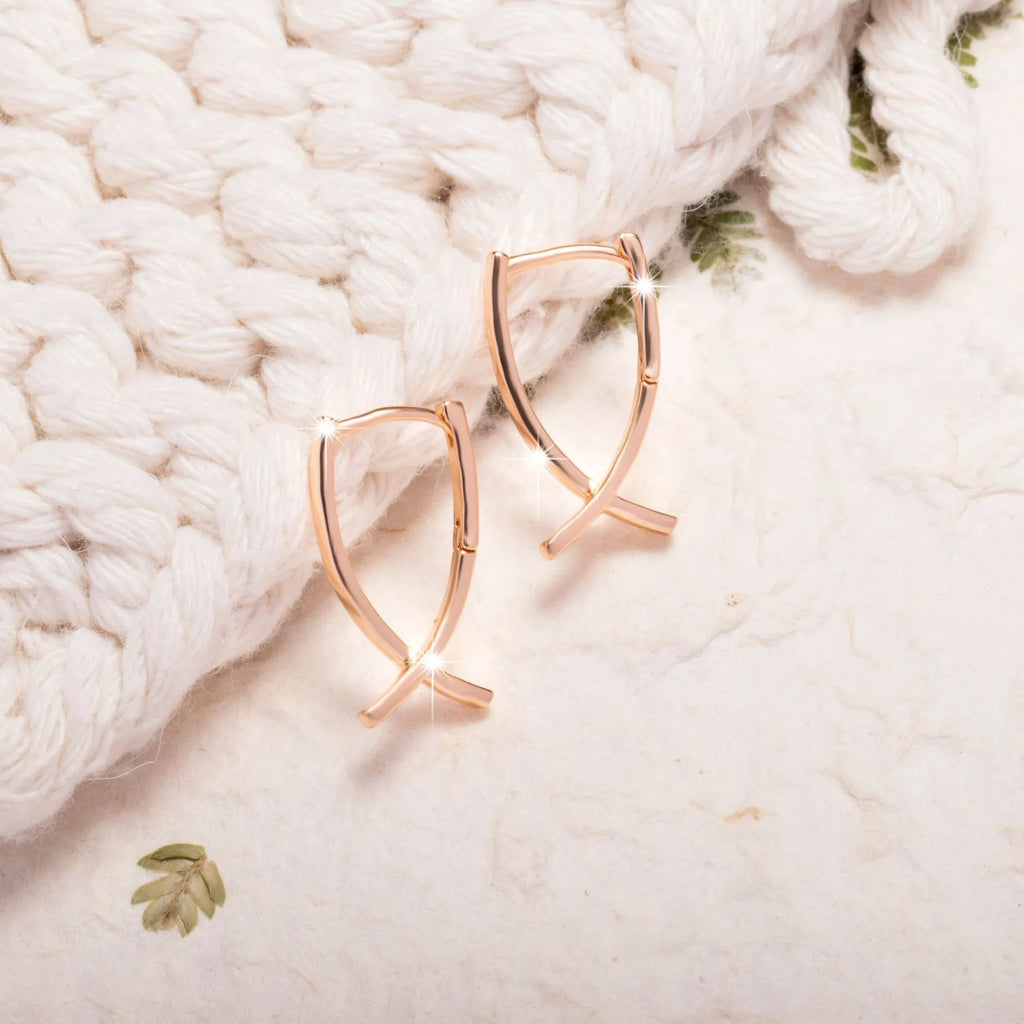 Rose gold cross shaped earrings with polished finish on copper construction