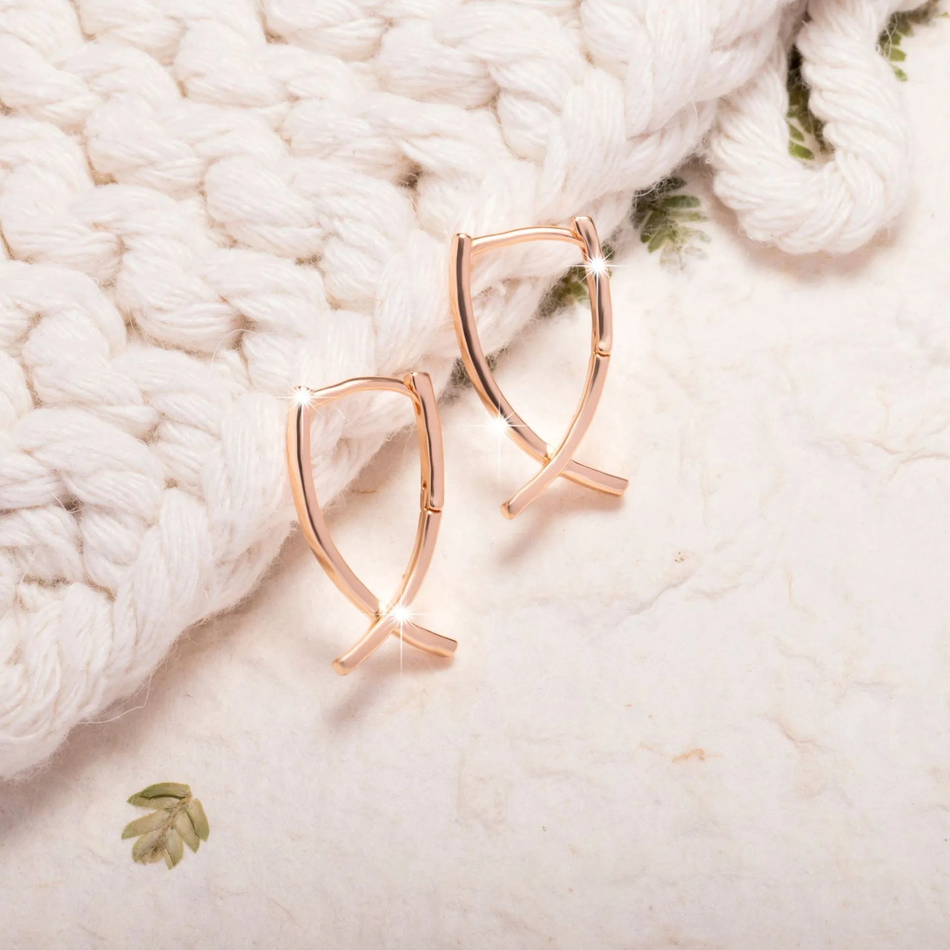 Rose gold cross shaped earrings with polished finish on copper construction