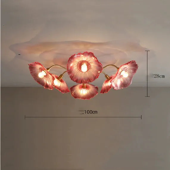 Modern white flower ceiling lamp with five light heads emitting a warm glow in a living room.