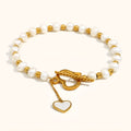 Gold pearl heart-shaped buckle bracelet on display