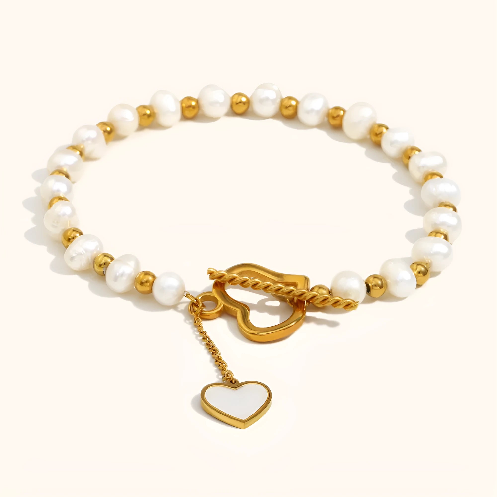 Gold pearl heart-shaped buckle bracelet on display