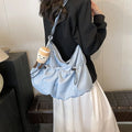 Soft green pleated foldable crossbody bag showing split pocket and internal mobile phone compartment