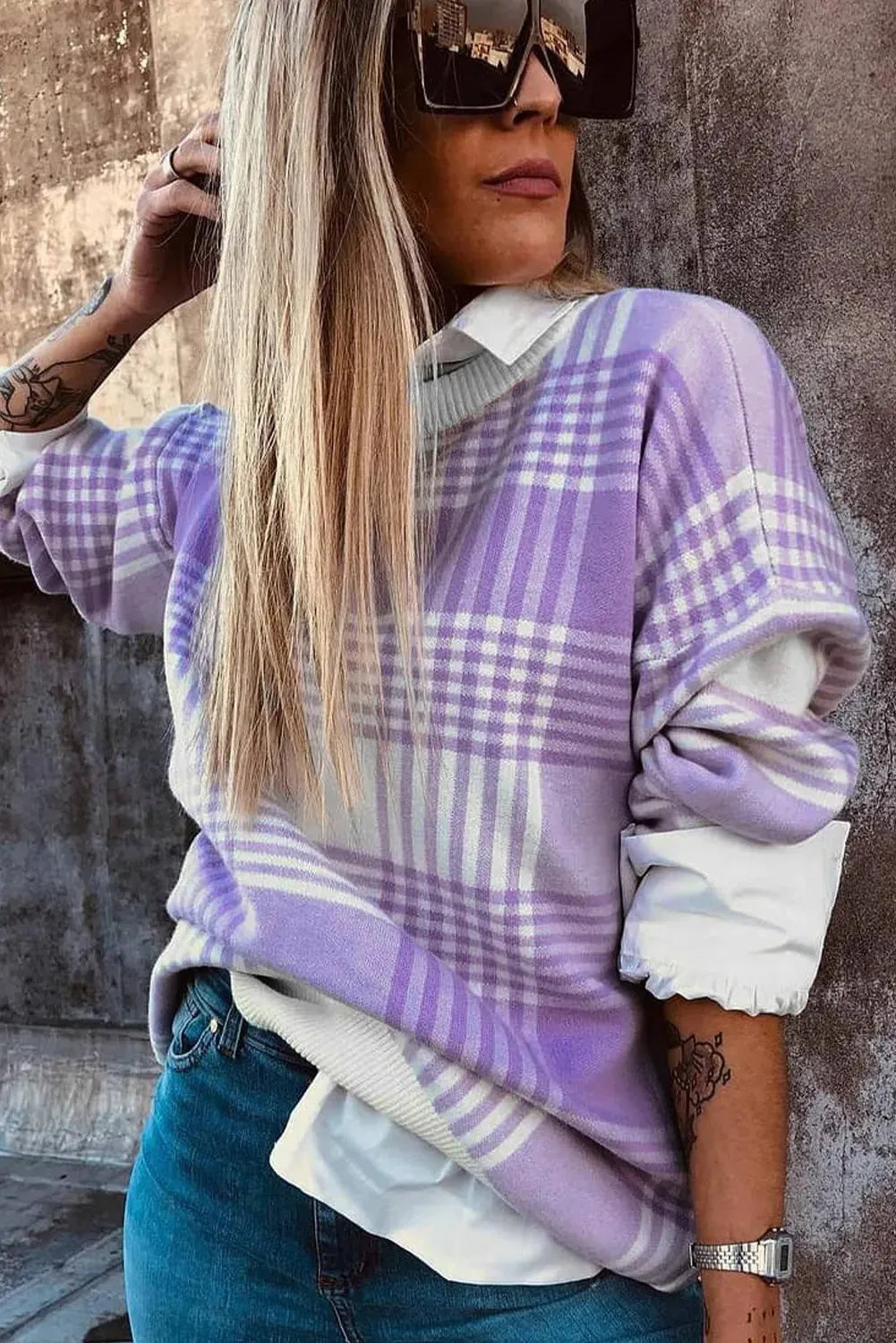 Lilac plaid print loose sweater with ribbed cuffs and hem on a hanger