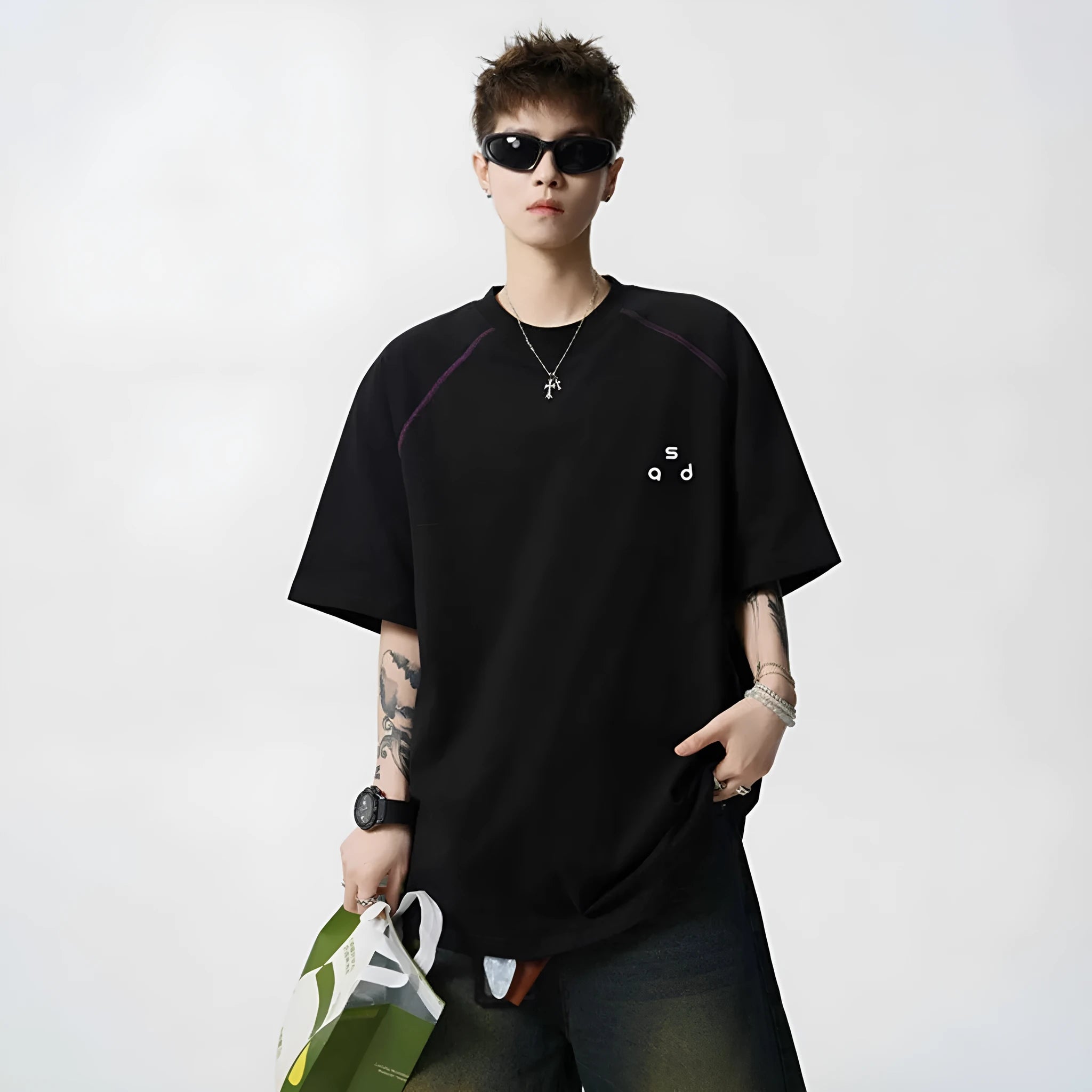 Loose fit black cotton t-shirt with a white letter print design on the front.
