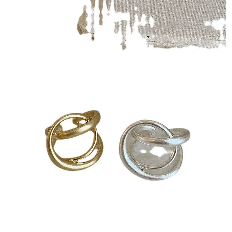 Geometric open ring with three-dimensional interlaced matte metal design in gold or silver electroplated finish