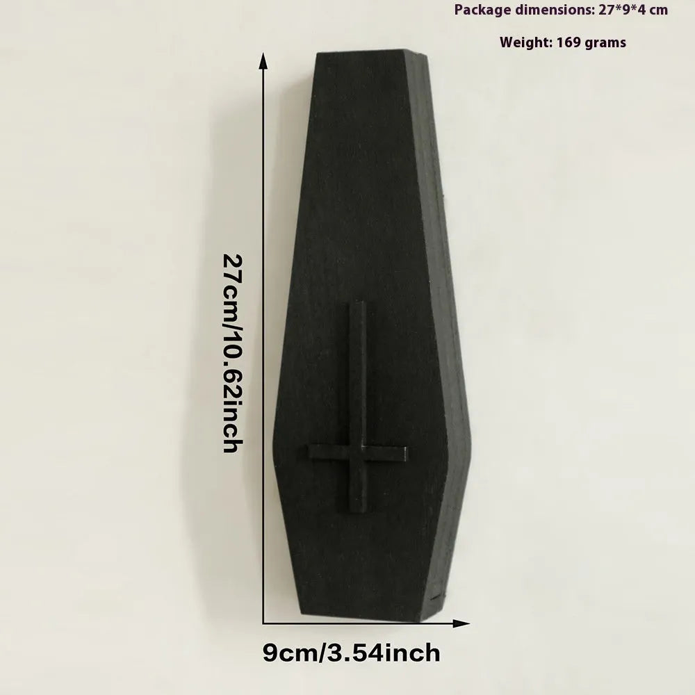 Black wooden cross-shaped wall shelf with a small ledge, measuring 27cm tall.