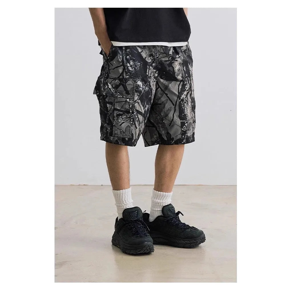 Man's loose straight-leg denim shorts in black on a hanger, showing mid-rise waist and zip fly.