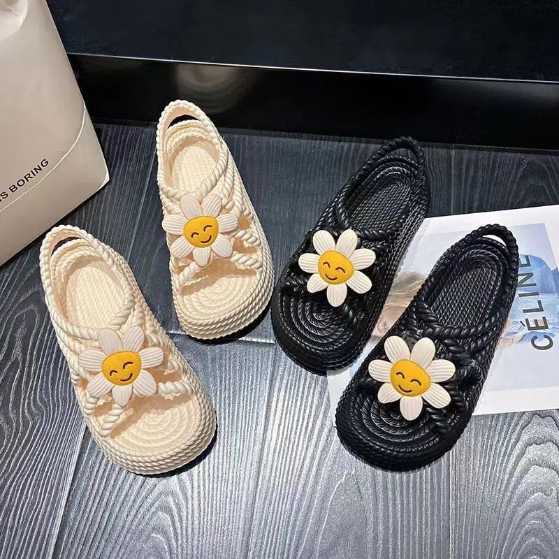 Beige women's flat sandals with a three-flower decoration and a non-slip PVC sole.