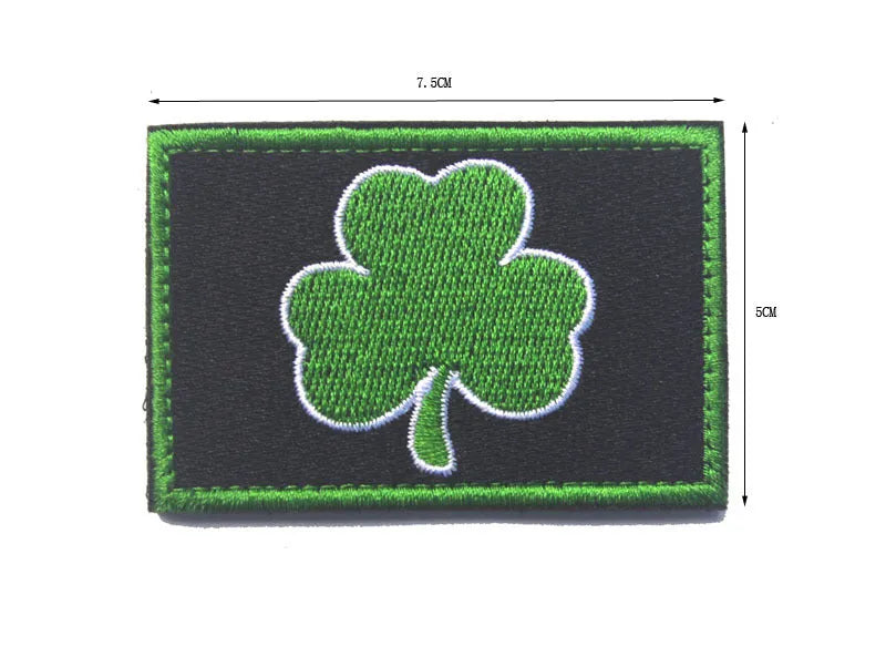 Outdoor embroidered fabric badge with Velcro strip backing on a green clover design.