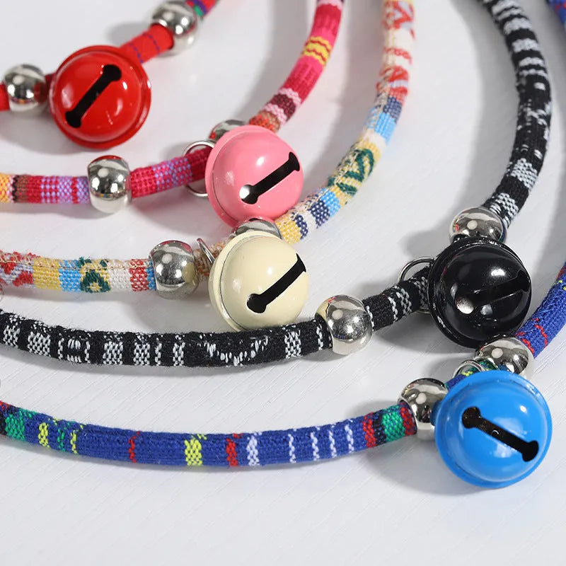 Ethnic patterned adjustable nylon pet collar with a metal buckle and bell in multiple colour options.