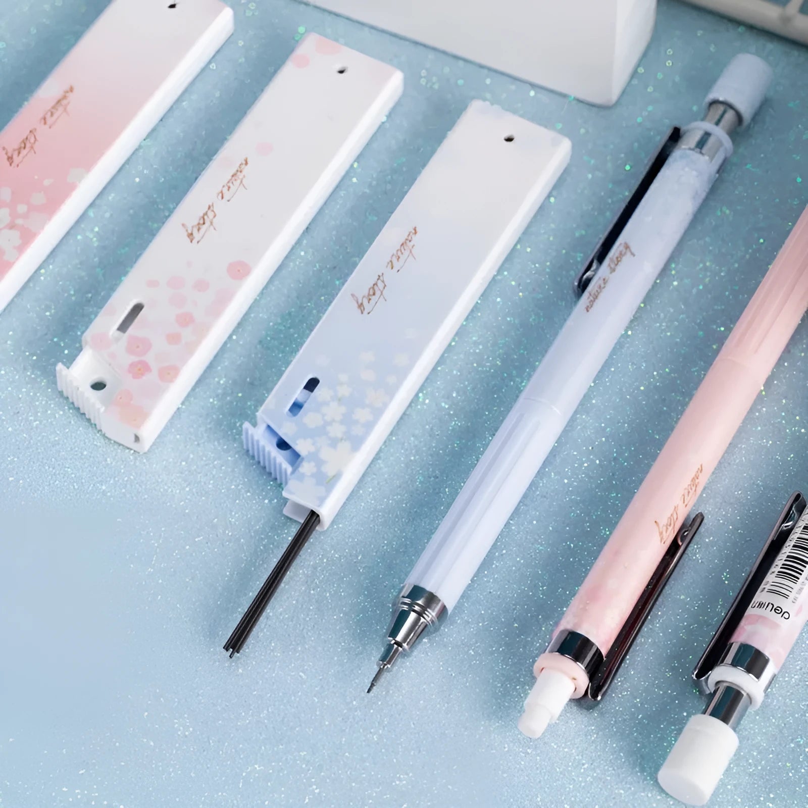 Three Sakura-design automatic pencils with mixed colours and 0.5mm HB refill boxes
