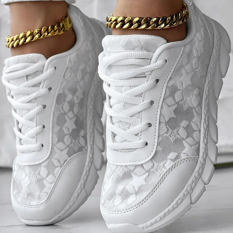 Women's canvas running shoes in white, black, blue, and pink colours with flat heel design