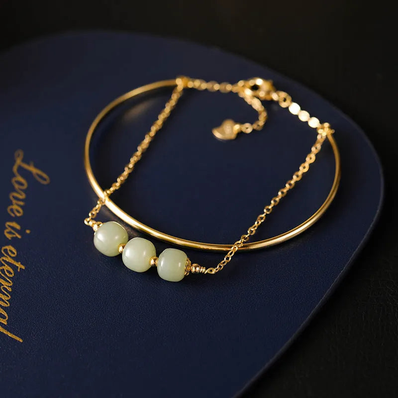 Women's Hetian jade lucky beads bracelet with gold inlay in single, double, and three-bead versions.