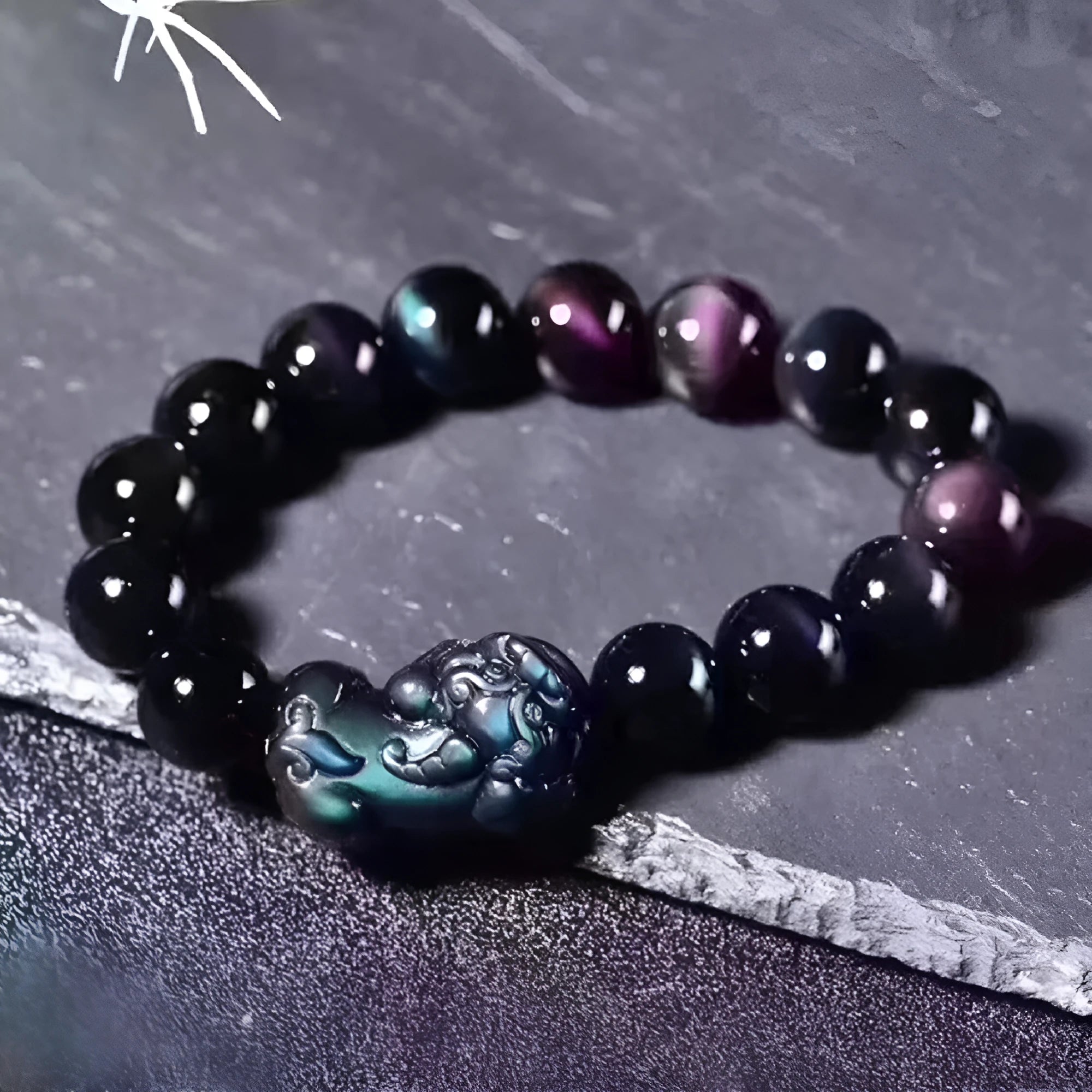 Natural ice colour eye obsidian crystal bracelet on a wrist, showing bead detail.