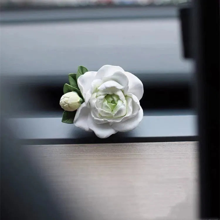 Jasmine scented solid gypsum car air vent diffuser in off white or green.