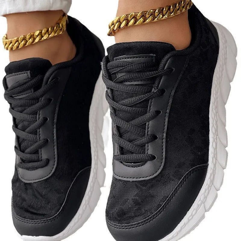 Women's canvas running shoes in white, black, blue, and pink colours with flat heel design