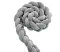 Braided spandex velvet baby bumper shown in a light grey colour, flexed to show its bendable design.