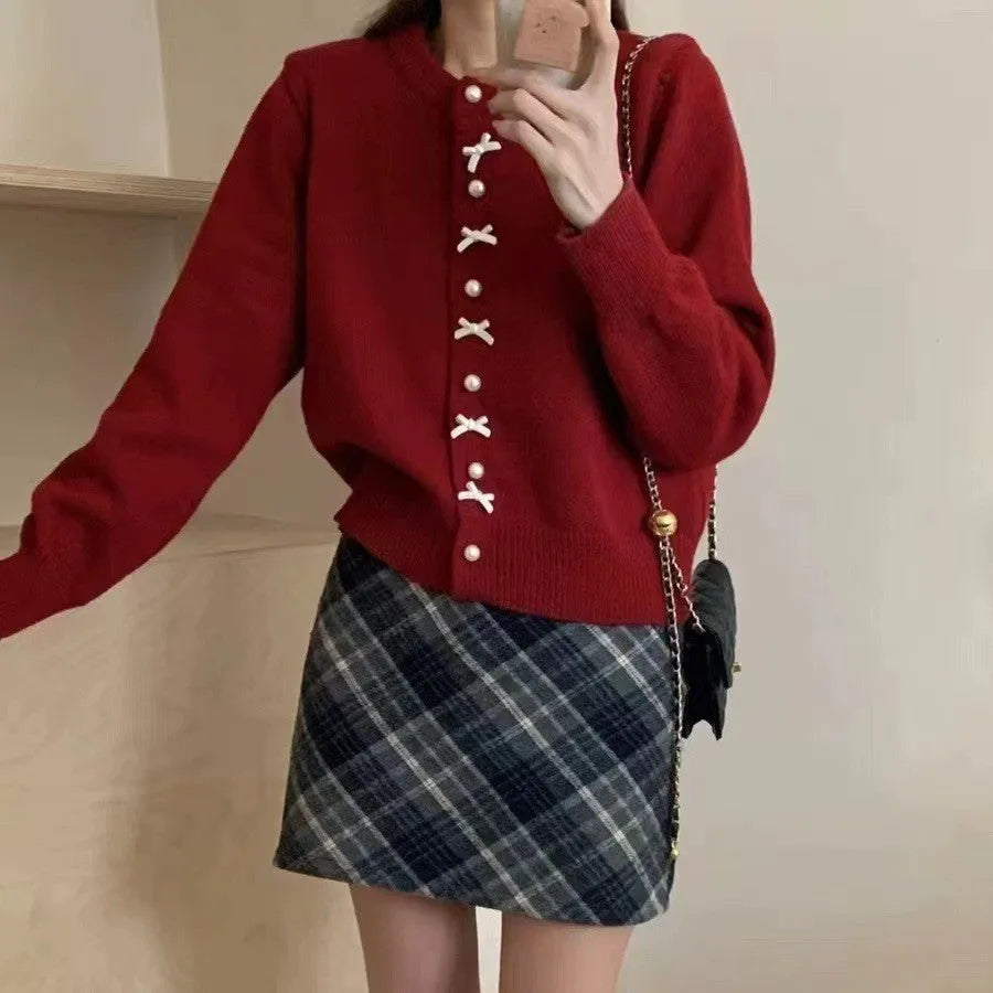 Women's acrylic cashmere cardigan sweater with bow and pearl button detail in nine colour options