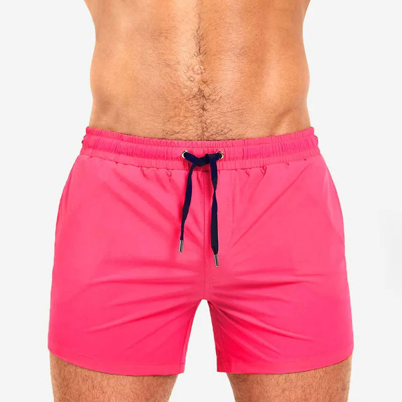 Men's solid colour polyester swimming shorts with mesh lining, shown in multiple colour options.