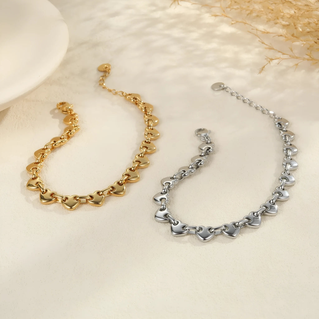 Hollowed-out heart bracelet in stainless steel with 18K gold plating showing simple geometric design