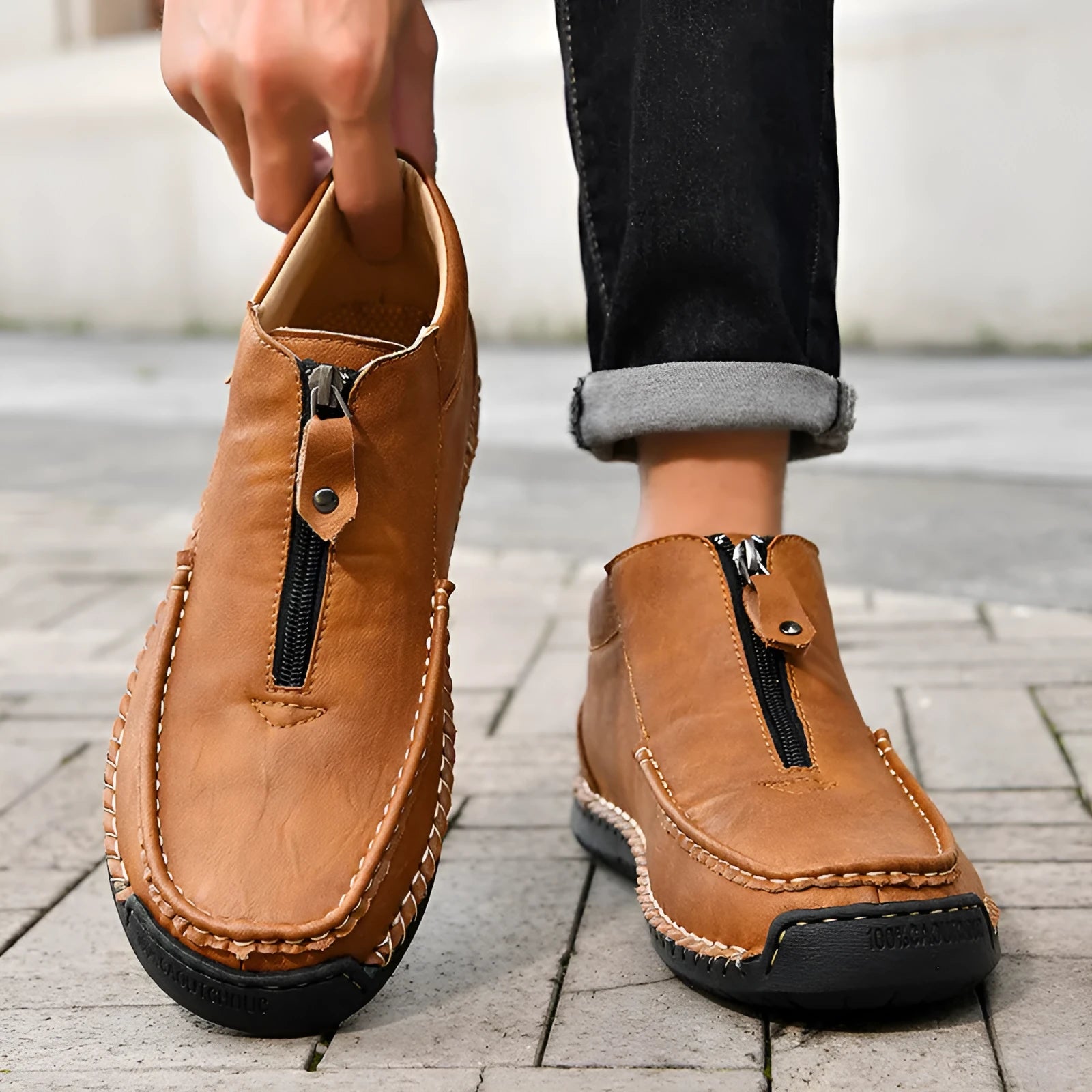 Men's black slip-on leather loafers with a round toe and rubber sole on a white background.