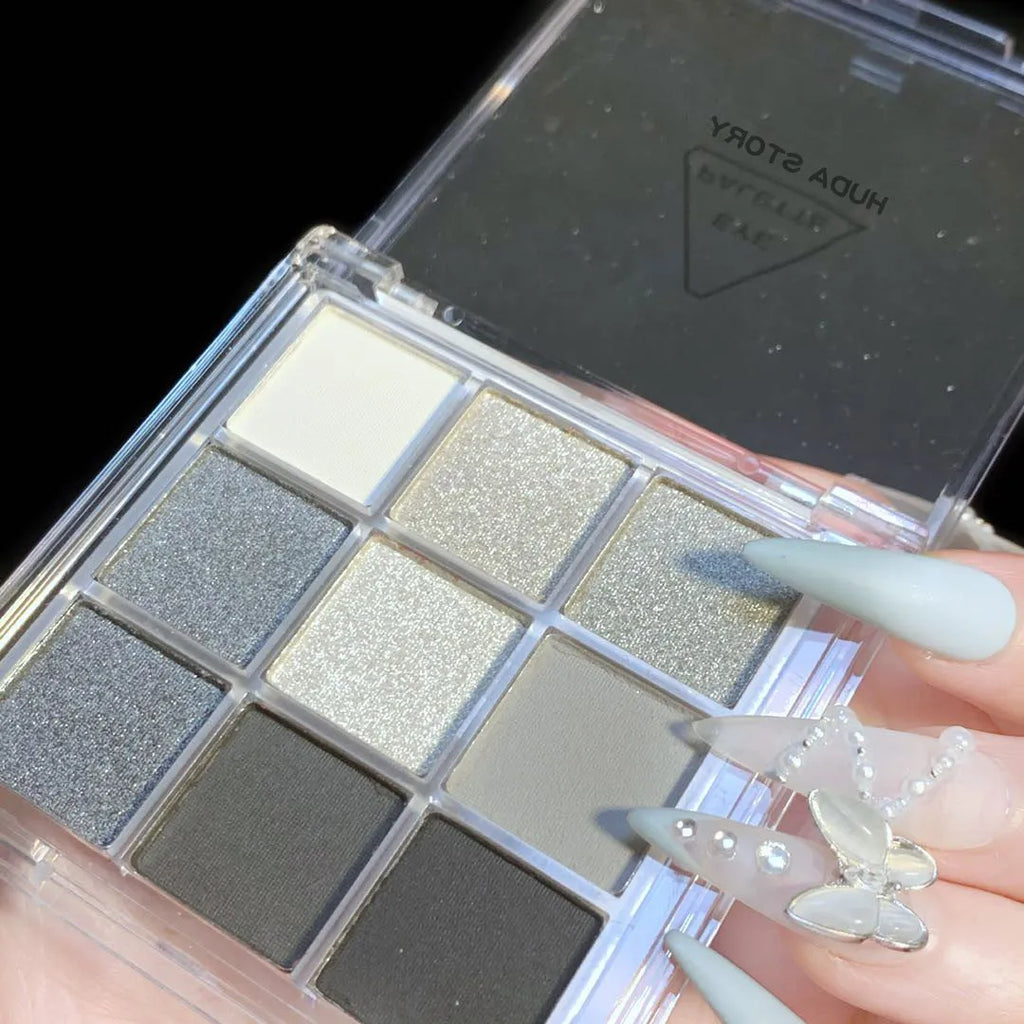 Smoked nine-colour eye shadow plate showing white, silver, black and iron grey pressed powder shades