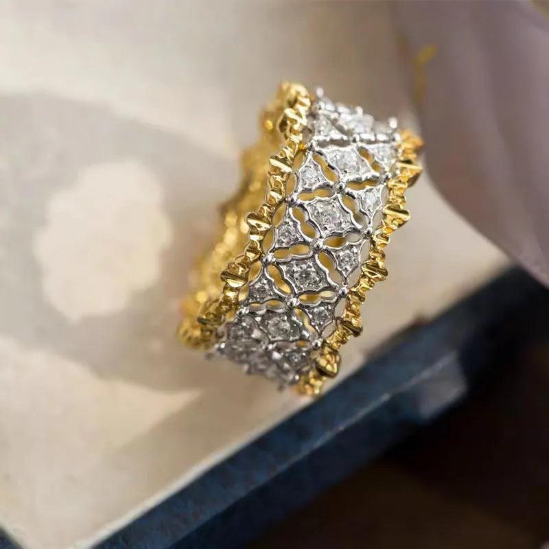Two-tone gold geometric zircon ring on display showing round shape and electroplated copper construction