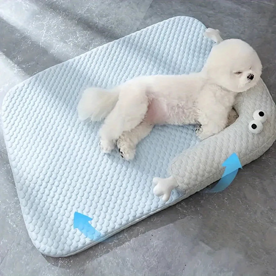 Blue pet bed cushion with cartoon monster face, showing non-slip base and folded size.