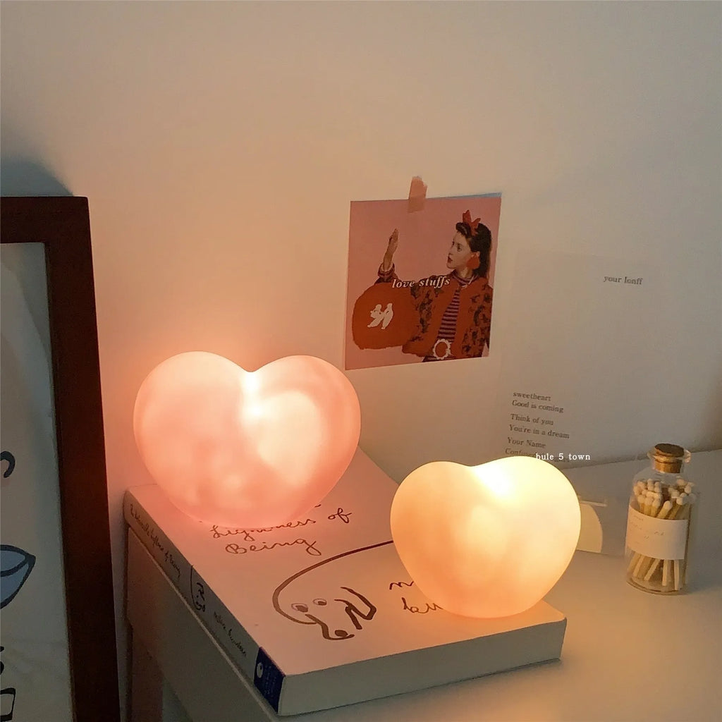 White vinyl atmosphere lamp with warm glow on wooden surface